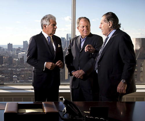 Three managing partners at DHC having a discussion in the boardroom