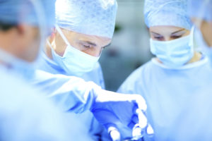 Team Of Surgeons Performing Surgery In Operating Room