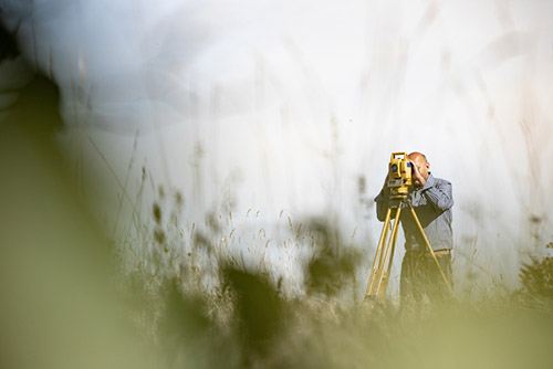 Land surveyor taking a reading