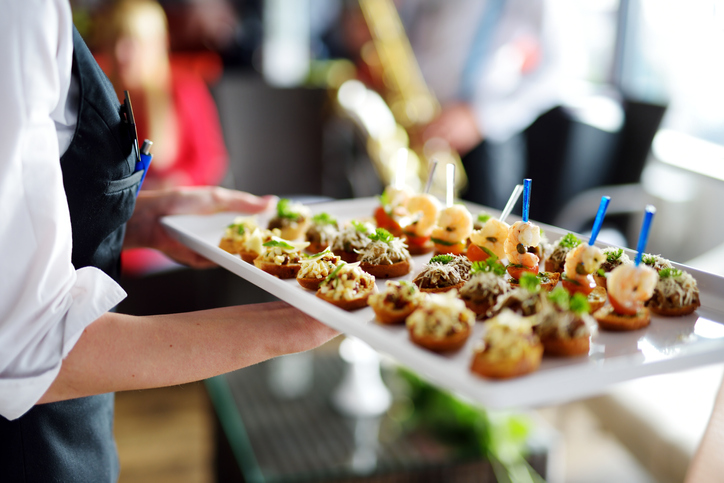 A server handing our samples at a dinner function