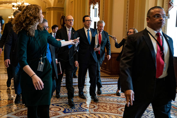 Treasury Secretary Steve Mnuchin, center, heading to meet the Senate minority leader, Chuck Schumer, in Washington on Tuesday.